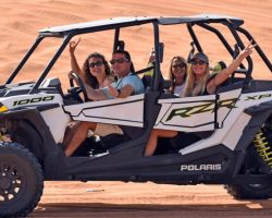 a family inside polaris 4 seater dune buggy