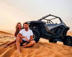 a couple with polaris dune buggy